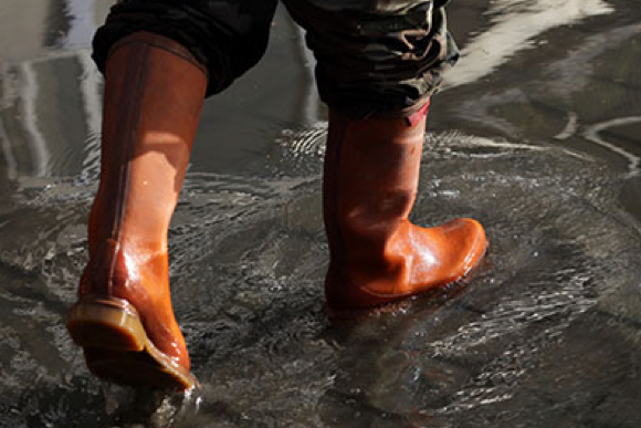 Rain boots on someone walking through water