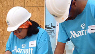 Two Marriott associates in blue shirts with hard hats
